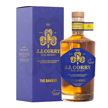 A bottle of JJ Corry's The Banner with its whiskey box on a plain background